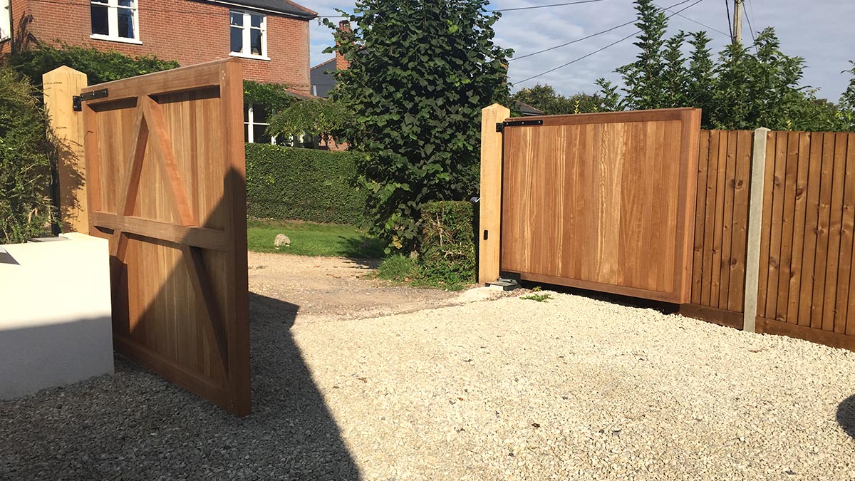 Hardwood entrance gates with underground automation, and matching fencing, Twyford