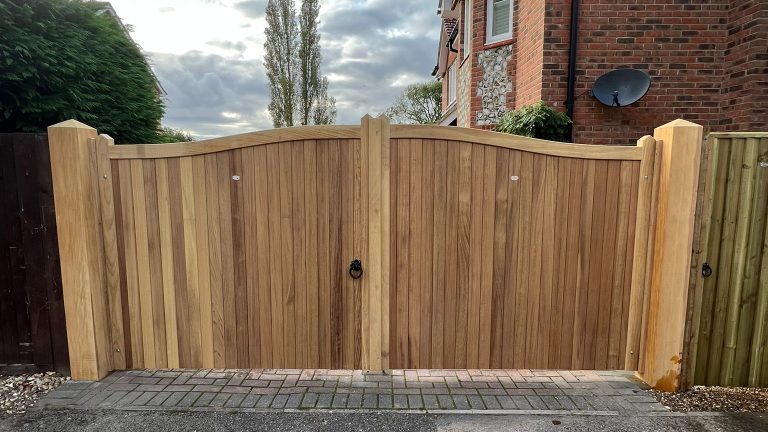 Swan-necked Iroko hardwood gates on Opepe posts installed in Nursling, Southampton Swan-necked Iroko hardwood gates on Opepe posts installed in Nursling, Southampton