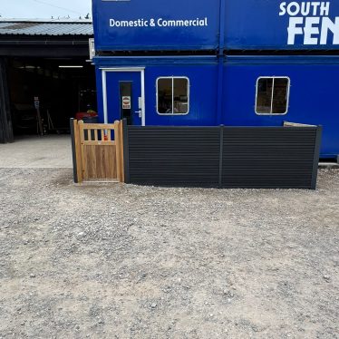 Composite fencing with hardwood garden gate